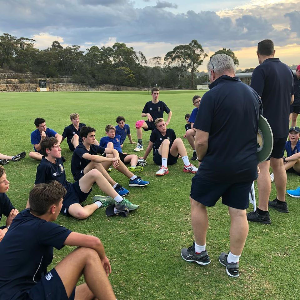 Junior side sitting down in front of the Cricket Appeal Team coaching staff